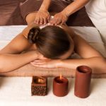 Masseur doing massage on woman body in the spa salon. Beauty treatment concept.