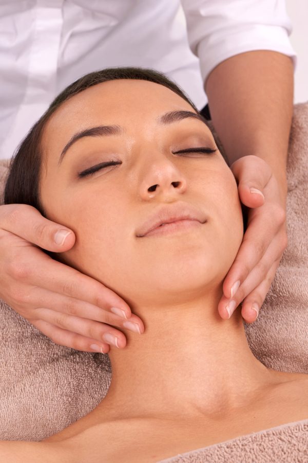 Stress be gone. Shot of a beautiful young woman enjoying a relaxing massage